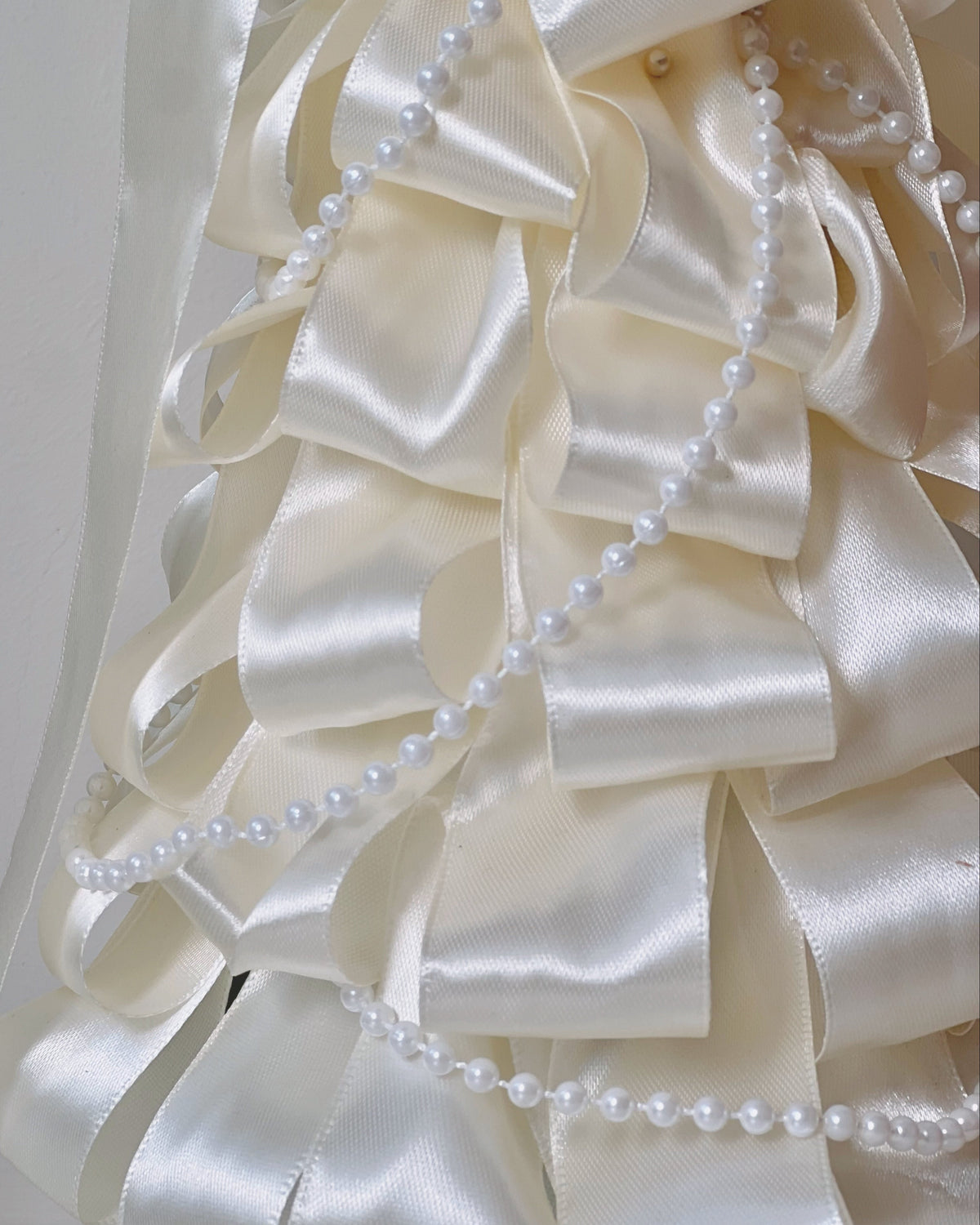 Another view of the White Satin dried Christmas tree with satin ribbon and pearl strings