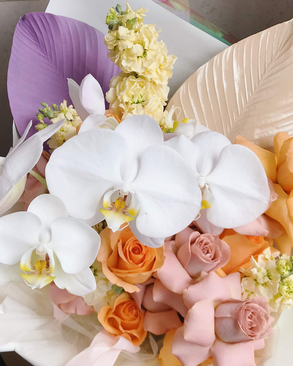 Iridescent purple and blue bouquet with Phalaenopsis orchid by Gathered+Styled Singapore