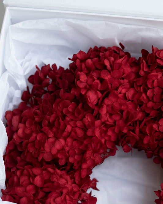 Another view of the red preserved hydrangea Christmas wreath with satin bows