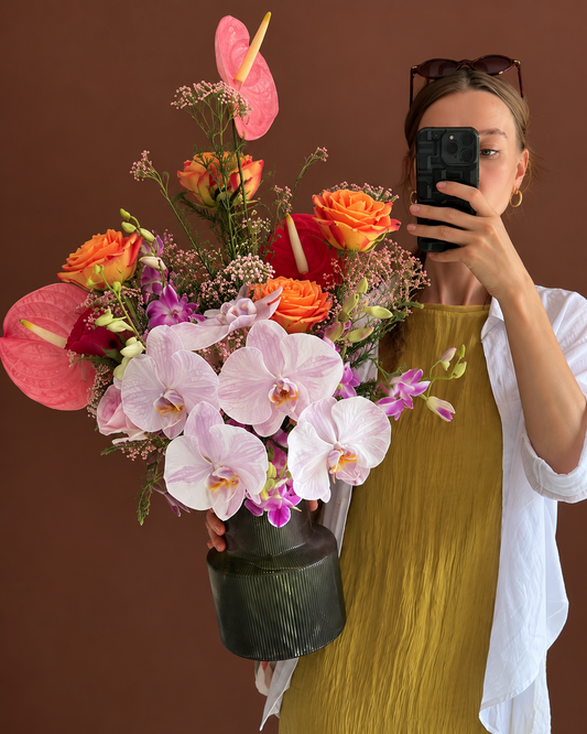 Florist holding Saffron, a Deepavali flower arrangement in a vase, for delivery in Singapore