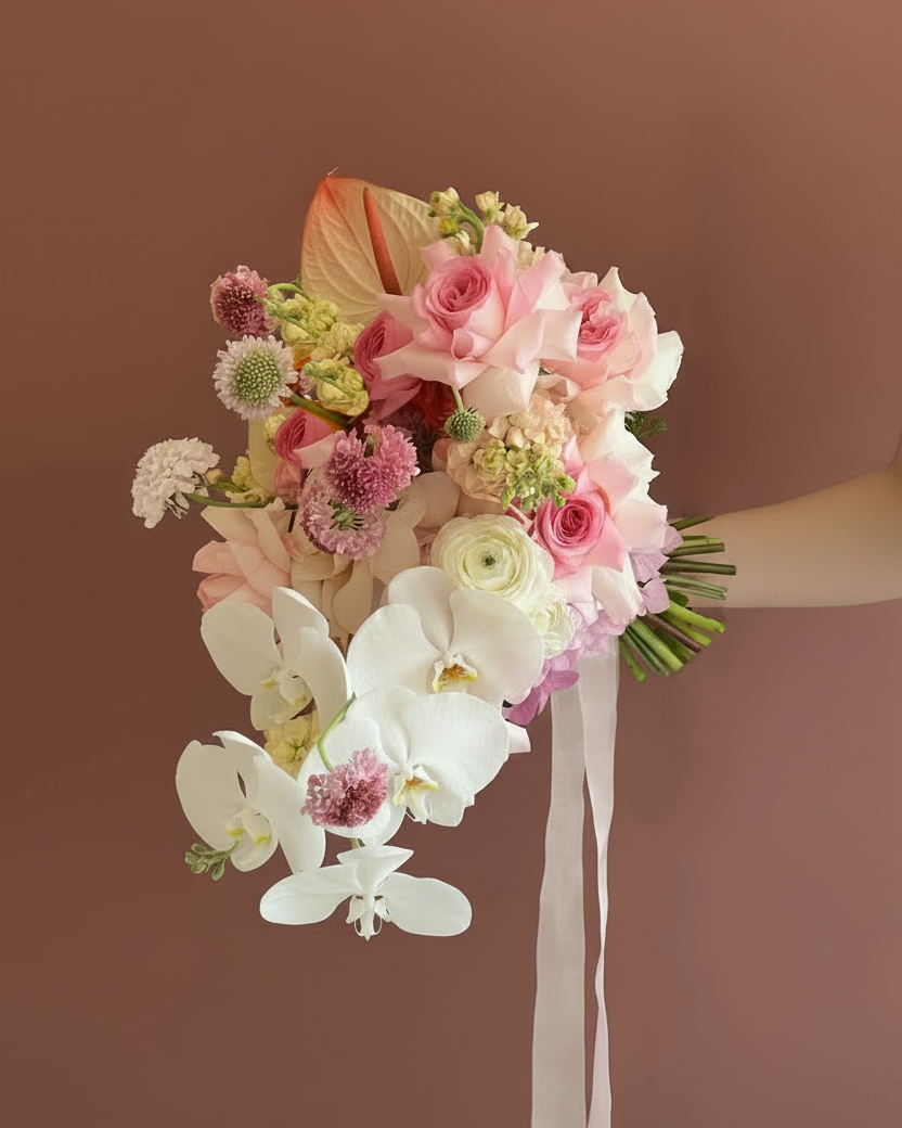 Soft pastel cascading bridal bouquet in blush and petal pink with phalaenopsis orchid — The Bridal Edit All Day Rose, Gathered+Styled Singapore