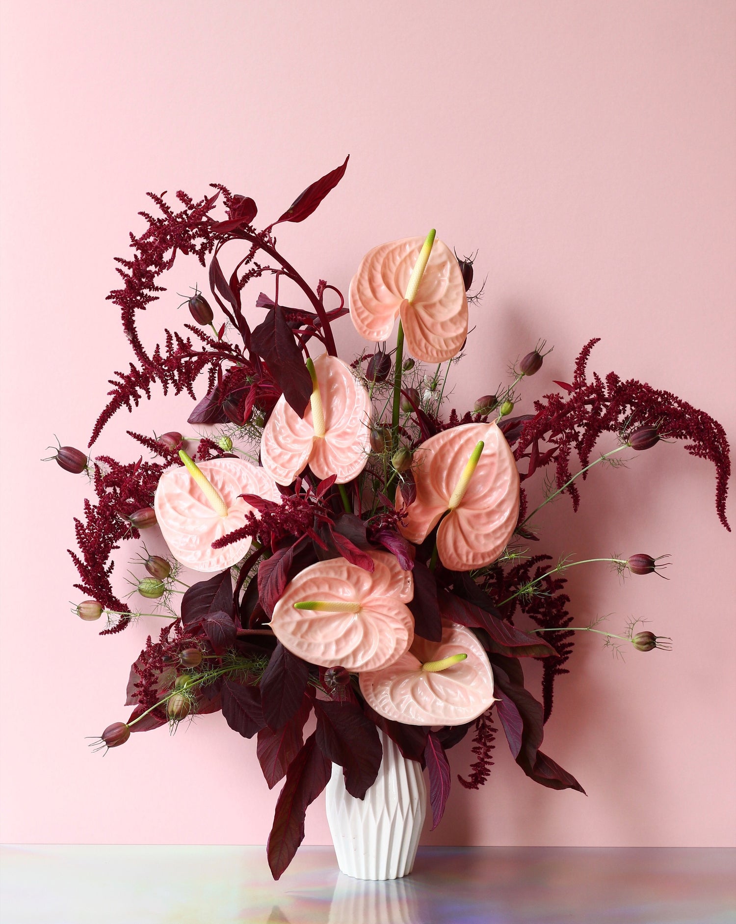 A bouquet of anthurium flowers with pink and dark burgundy foliage in Singapore